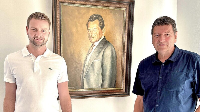 Drei Baugenerationen: Thomas Kolbeck (links) und sein Vater Peter sind die Geschäftsführer. Auf dem Bild dahinter ein Porträt des Further Kunstmalers Hermann Scheuer, das den 1981 verstorbenen Franz Kolbeck zeigt.