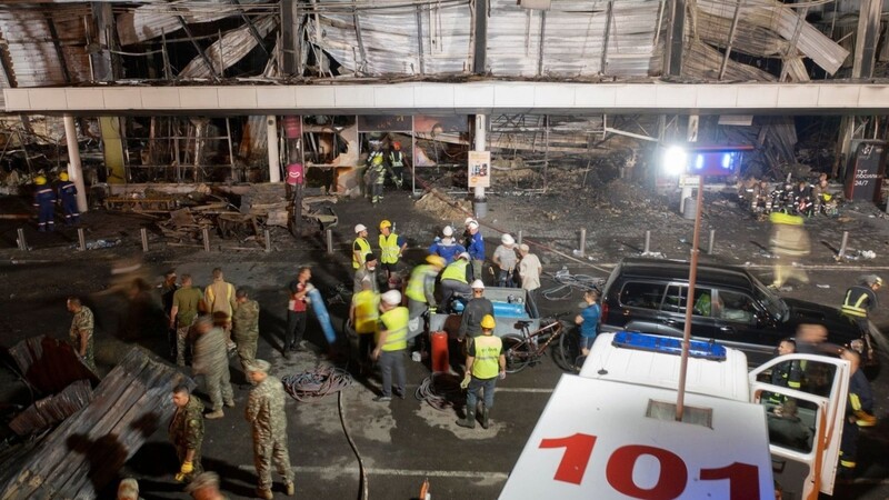 Feuerwehrleute bekämpfen den Brand in einem Einkaufszentrum nach einem Raketenangriff in Krementschuk.