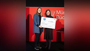 Kristina Pöschl (l.) bekommt den Scheck überreicht. Kristina Pöschl (l.) bekommt den Scheck überreicht.