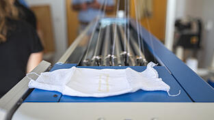 Mit einer Strickmaschine werden Textilantennen in Kleidung integriert. Mit einer Strickmaschine werden Textilantennen in Kleidung integriert.